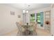 Bright dining area featuring a glass-top table and wicker chairs at 2875 Lomond Dr, Palm Harbor, FL 34684