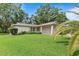 Well-maintained front lawn with mature landscaping at 2875 Lomond Dr, Palm Harbor, FL 34684