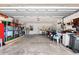 Spacious garage with concrete floor, storage shelving, and back door access at 2875 Lomond Dr, Palm Harbor, FL 34684