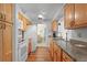 Bright kitchen features wood cabinets, granite countertops, and modern white appliances at 2875 Lomond Dr, Palm Harbor, FL 34684