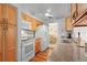 Bright kitchen features wood cabinets, granite countertops, and modern white appliances at 2875 Lomond Dr, Palm Harbor, FL 34684