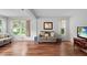 Spacious living room with hardwood floors, a large window, and comfortable seating at 2875 Lomond Dr, Palm Harbor, FL 34684