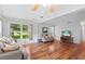 Spacious living room with hardwood floors, a large window, and comfortable seating at 2875 Lomond Dr, Palm Harbor, FL 34684