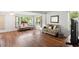 Bright and airy living room features hardwood floors and large windows with natural light at 2875 Lomond Dr, Palm Harbor, FL 34684