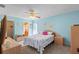 Comfortable main bedroom with a ceiling fan, carpeted floor, and access to the bathroom at 2875 Lomond Dr, Palm Harbor, FL 34684