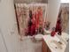 Bathroom featuring a single vanity, tile flooring and a shower-tub combination with curtain at 29413 Caddyshack Ln, San Antonio, FL 33576