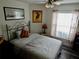 Bedroom with decorative wrought iron bed frame, ceiling fan, wood laminate flooring and natural lighting at 29413 Caddyshack Ln, San Antonio, FL 33576