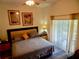 Comfortable bedroom featuring a ceiling fan, natural light and stylish decor and wood laminate flooring at 29413 Caddyshack Ln, San Antonio, FL 33576