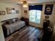 Bedroom featuring wood laminate flooring, a ceiling fan and decorative wall art at 29413 Caddyshack Ln, San Antonio, FL 33576