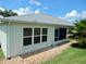 Exterior view featuring a well-maintained exterior, grey roof, and a charming screened-in lanai at 29413 Caddyshack Ln, San Antonio, FL 33576