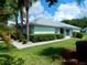 The exterior features lush green grass and beautiful hedges, enhancing the home's curb appeal at 29413 Caddyshack Ln, San Antonio, FL 33576