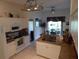 Functional kitchen featuring granite countertops, white cabinets, and stainless steel appliances, with an adjacent dining area at 29413 Caddyshack Ln, San Antonio, FL 33576
