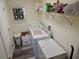 Laundry room with side by side washer and dryer on wood laminate flooring at 29413 Caddyshack Ln, San Antonio, FL 33576
