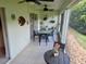 Enclosed patio featuring a ceiling fan, tile flooring, outdoor furniture and a view of the yard at 29413 Caddyshack Ln, San Antonio, FL 33576