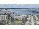 Daytime aerial view of the condo complex, parking lot, and surrounding neighborhood by the water at 399 150Th Ave # 315, Madeira Beach, FL 33708