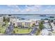 Aerial view of condos with a water view from upper floors and lush landscaping at 399 150Th Ave # 315, Madeira Beach, FL 33708