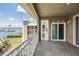 View of marina, the building, landscape, and the sky from the tiled balcony with white railings at 399 150Th Ave # 315, Madeira Beach, FL 33708
