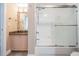 Bathroom with a glass shower enclosure and decorative seashell framed mirror adding coastal charm at 399 150Th Ave # 315, Madeira Beach, FL 33708