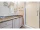 Bathroom featuring granite countertop, wooden drawers and a walk-in shower with glass doors at 399 150Th Ave # 315, Madeira Beach, FL 33708