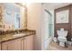 Bathroom featuring a sink with granite countertop, and walk-in shower with glass doors at 399 150Th Ave # 315, Madeira Beach, FL 33708