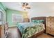 Bedroom featuring hardwood floors, shuttered windows and a wooden headboard at 399 150Th Ave # 315, Madeira Beach, FL 33708