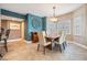 Dining room featuring neutral chairs, a wooden table, and a decorative seashell wall art piece at 399 150Th Ave # 315, Madeira Beach, FL 33708