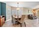 Elegant dining room with a wood table set, tile floors, and abundant natural light from large windows at 399 150Th Ave # 315, Madeira Beach, FL 33708