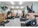 Bright exercise room featuring multiple machines, carpeted floors and walls at 399 150Th Ave # 315, Madeira Beach, FL 33708