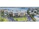 Low-angle aerial view of the condo complex on a sunny day near the water at 399 150Th Ave # 315, Madeira Beach, FL 33708