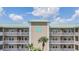 Close up of the condo building showing covered parking and a balcony at 399 150Th Ave # 315, Madeira Beach, FL 33708