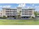 A charming condo building with a well-manicured lawn and covered parking at 399 150Th Ave # 315, Madeira Beach, FL 33708