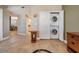 Hallway featuring a laundry closet, tiled floors, and views into the dining and kitchen areas at 399 150Th Ave # 315, Madeira Beach, FL 33708