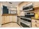 Modern kitchen with stainless steel appliances, granite counters, and open layout to the dining area at 399 150Th Ave # 315, Madeira Beach, FL 33708