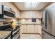 Updated kitchen featuring light wood cabinets, stainless steel appliances, and a skylight for natural lighting at 399 150Th Ave # 315, Madeira Beach, FL 33708