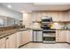 Well-appointed kitchen featuring modern appliances, granite countertops, and ample cabinet space at 399 150Th Ave # 315, Madeira Beach, FL 33708