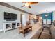 Inviting living area with tile floors, ceiling fan and sliding door leading to a balcony at 399 150Th Ave # 315, Madeira Beach, FL 33708