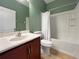 Bathroom featuring a vanity, toilet, and shower with a white shower curtain against green paint at 4079 Pacente Loop, Wesley Chapel, FL 33543