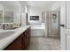 Well lit bathroom with double sinks, soaking tub, and a glass enclosed shower at 4079 Pacente Loop, Wesley Chapel, FL 33543