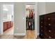 Walk-in closet featuring ample shelving and hanging space with easy access to the bathroom at 4079 Pacente Loop, Wesley Chapel, FL 33543