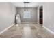 Unfurnished dining or living room with natural lighting and easy access to kitchen at 4079 Pacente Loop, Wesley Chapel, FL 33543