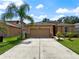 Charming single-story home with attached garage and a long driveway at 4079 Pacente Loop, Wesley Chapel, FL 33543