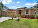 Charming single-story home with a well-manicured lawn and stone accents at 4079 Pacente Loop, Wesley Chapel, FL 33543