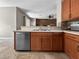 Kitchen area with wood cabinets, light countertops, and stainless steel appliances at 4079 Pacente Loop, Wesley Chapel, FL 33543