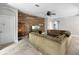 Comfortable living room featuring tile floors, a wood accent wall, and ample seating at 4079 Pacente Loop, Wesley Chapel, FL 33543