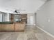 Bright living room with tile floors, an accent wall, and a ceiling fan at 4079 Pacente Loop, Wesley Chapel, FL 33543