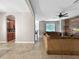 Open concept living room featuring stylish wood accent wall, large sofa and great natural light at 4079 Pacente Loop, Wesley Chapel, FL 33543