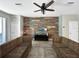 Open concept living room with views of the wood accent wall and tile flooring at 4079 Pacente Loop, Wesley Chapel, FL 33543