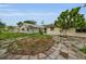 Backyard featuring lush plants, a brick circular design, and concrete walkway at 4143 Gray Squirrel Ln, New Port Richey, FL 34653