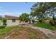 Landscaped backyard with concrete walkway, garden area and lush greenery at 4143 Gray Squirrel Ln, New Port Richey, FL 34653