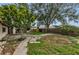 Spacious backyard area with patio, wooden fence, shed, and lush greenery at 4143 Gray Squirrel Ln, New Port Richey, FL 34653